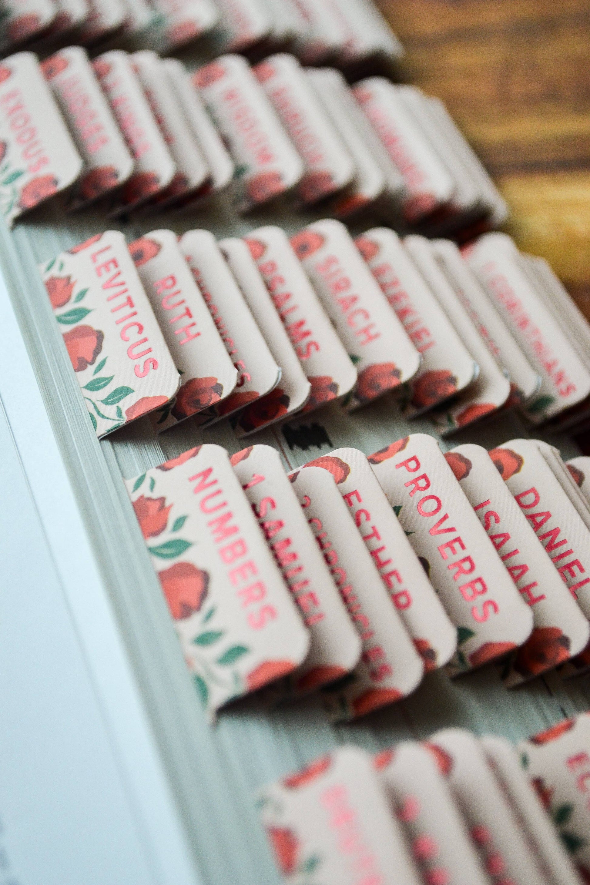 Row of small rectangular items with printed text on a wooden surface