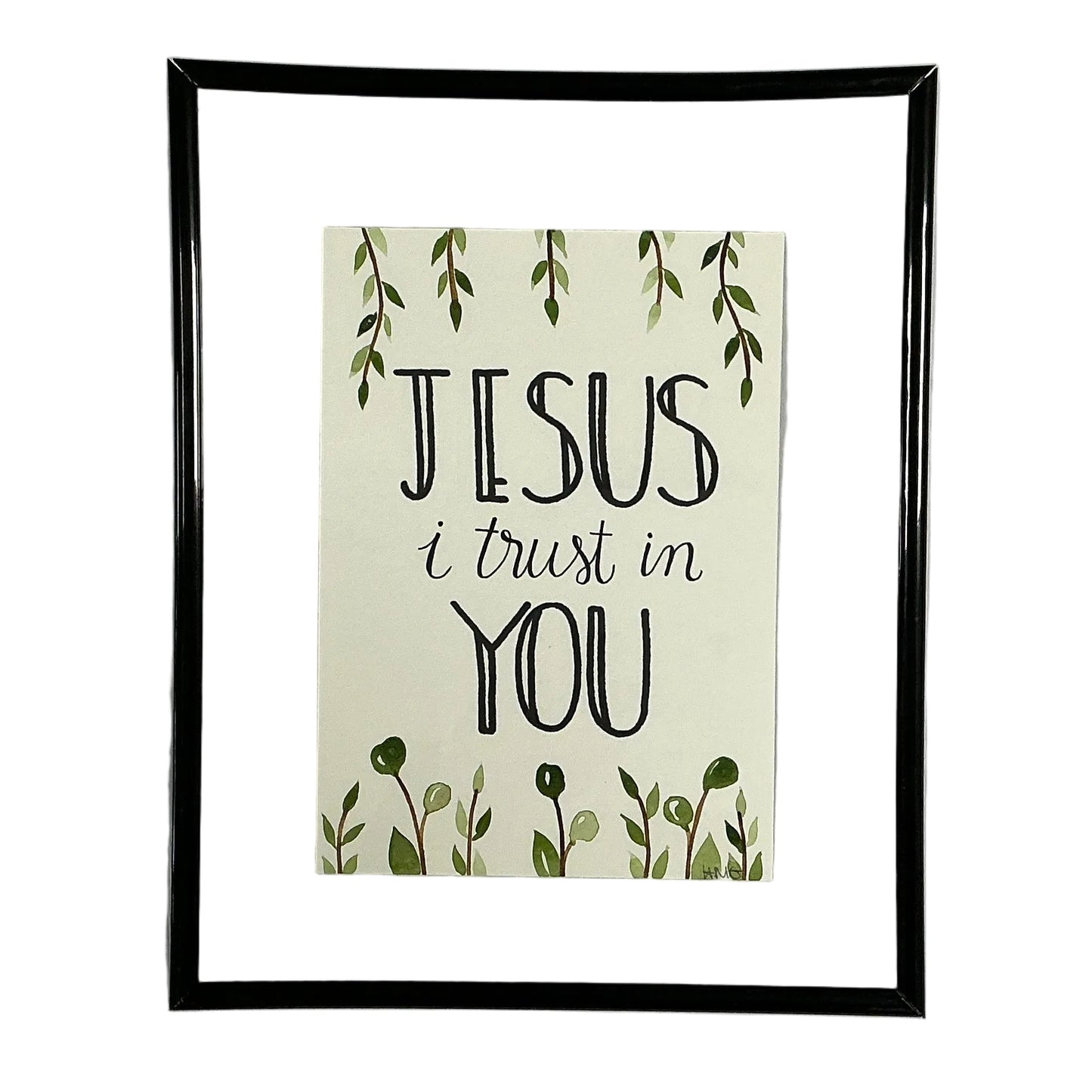 Framed print with 'Jesus I trust in You' text on a white shirt.