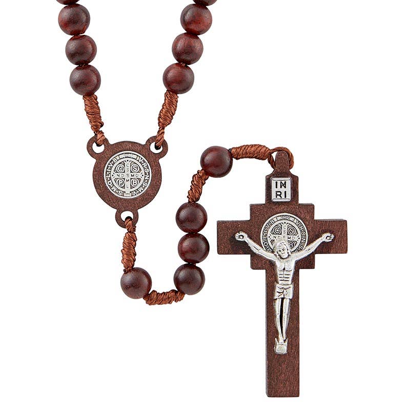 Wooden rosary with a cross and Saint Benedict medal on a white background