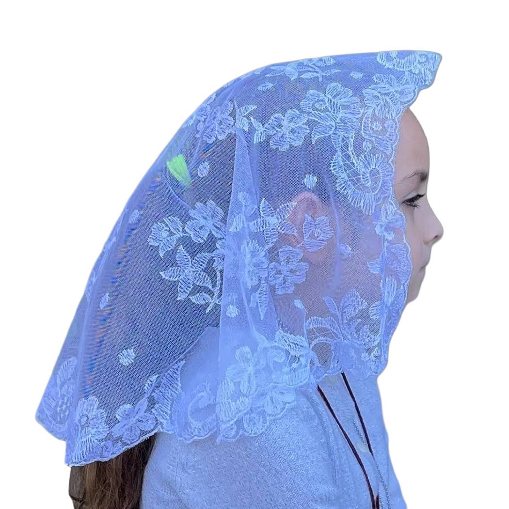 Person wearing a blue lace veil on a white background