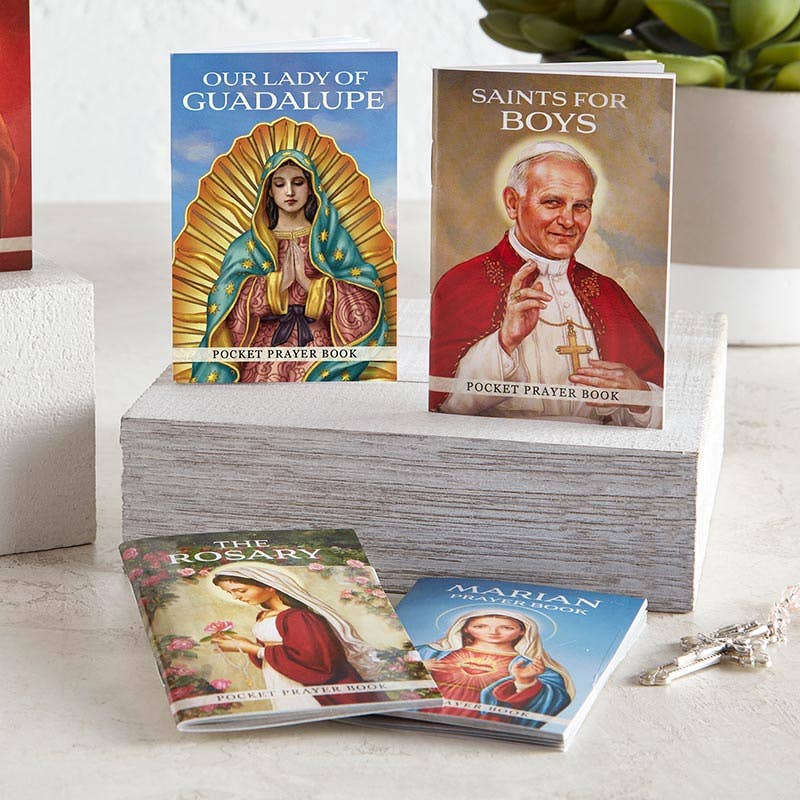 Collection of pocket prayer books featuring religious icons on a white surface.