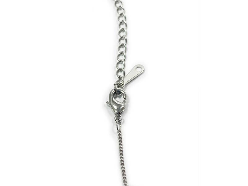 Close-up of a silver chain necklace on a white background