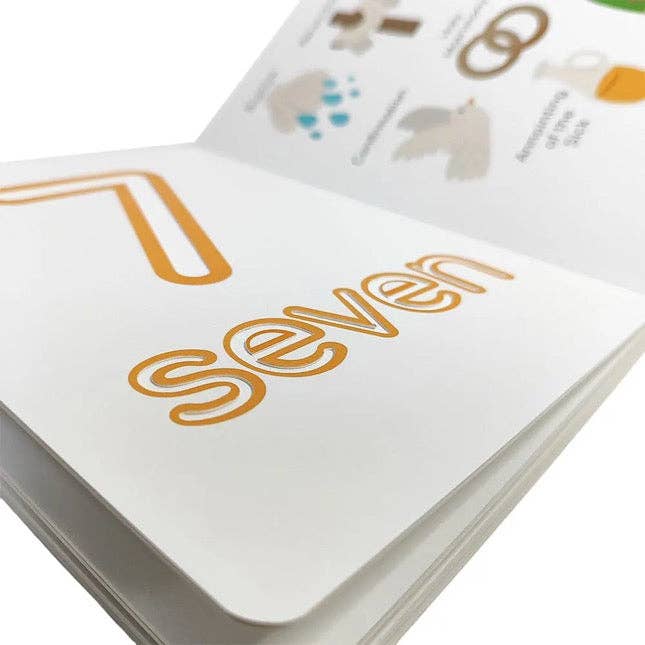 Card with the number 'seven' printed on it, featuring a white background and orange text.