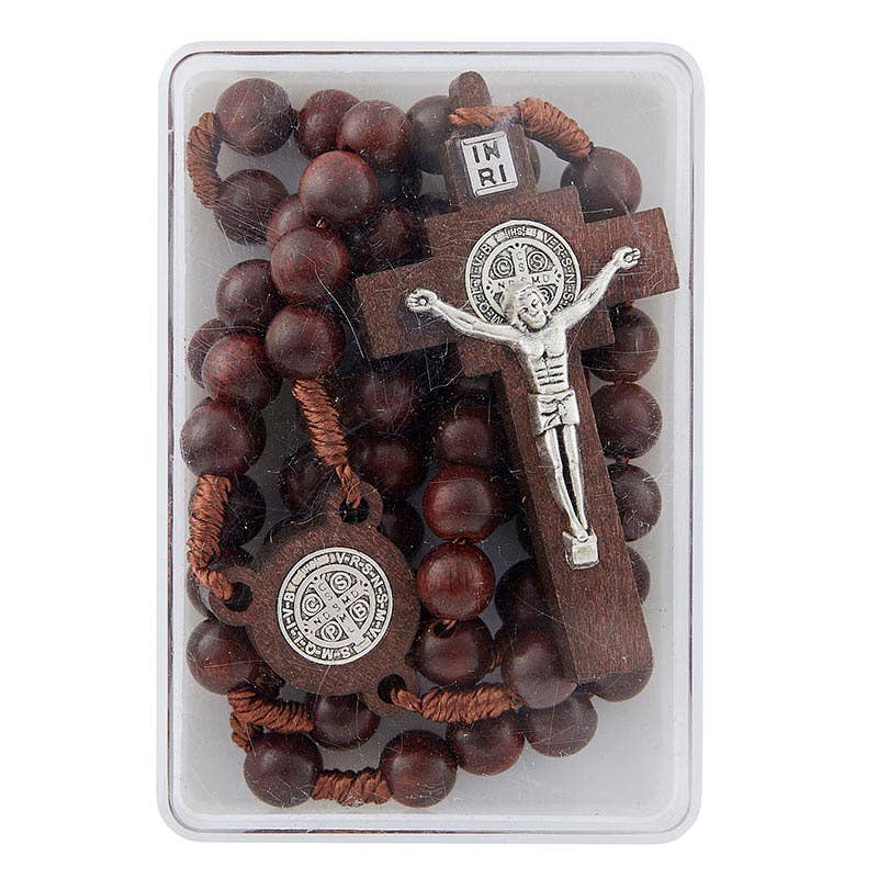 Wooden rosary with silver crucifix and Saint Benedict medals on a white background
