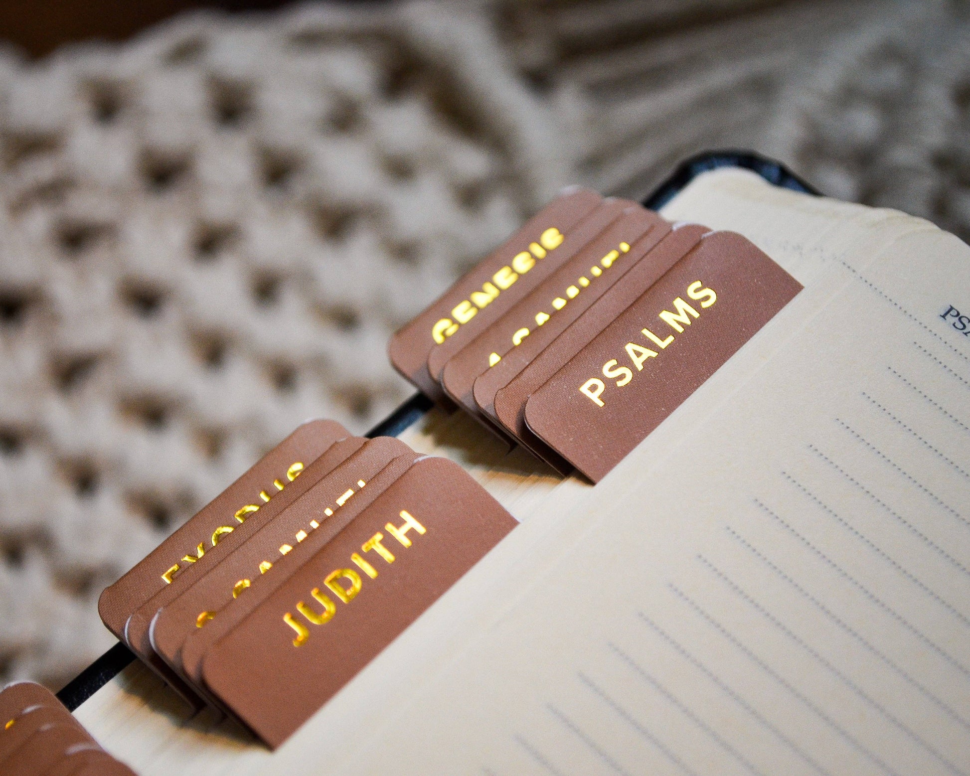 Brown leather bookmarks with gold text on a notebook