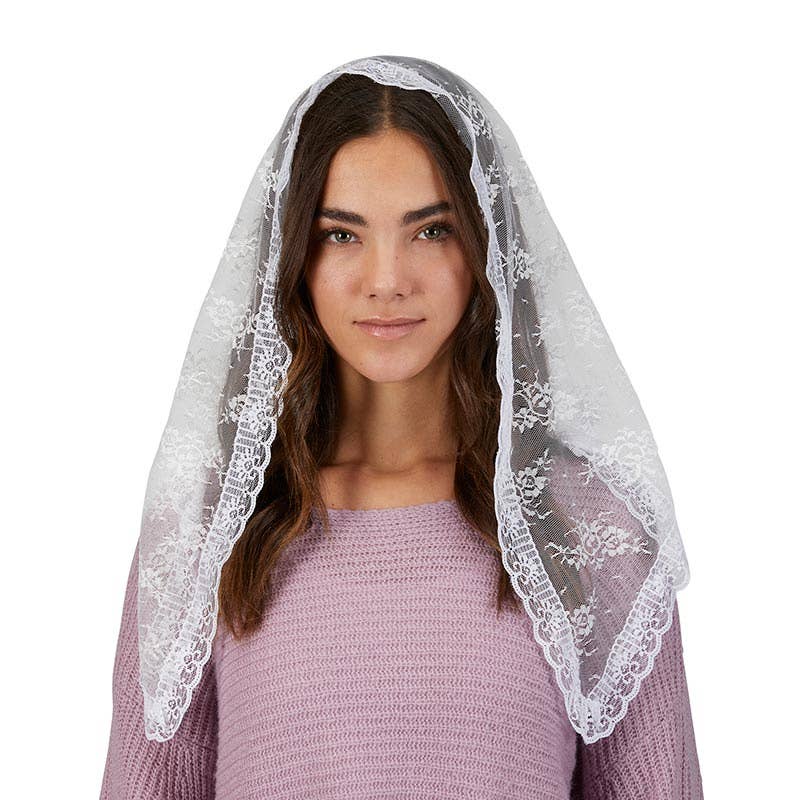 Woman wearing a white lace veil on a white background