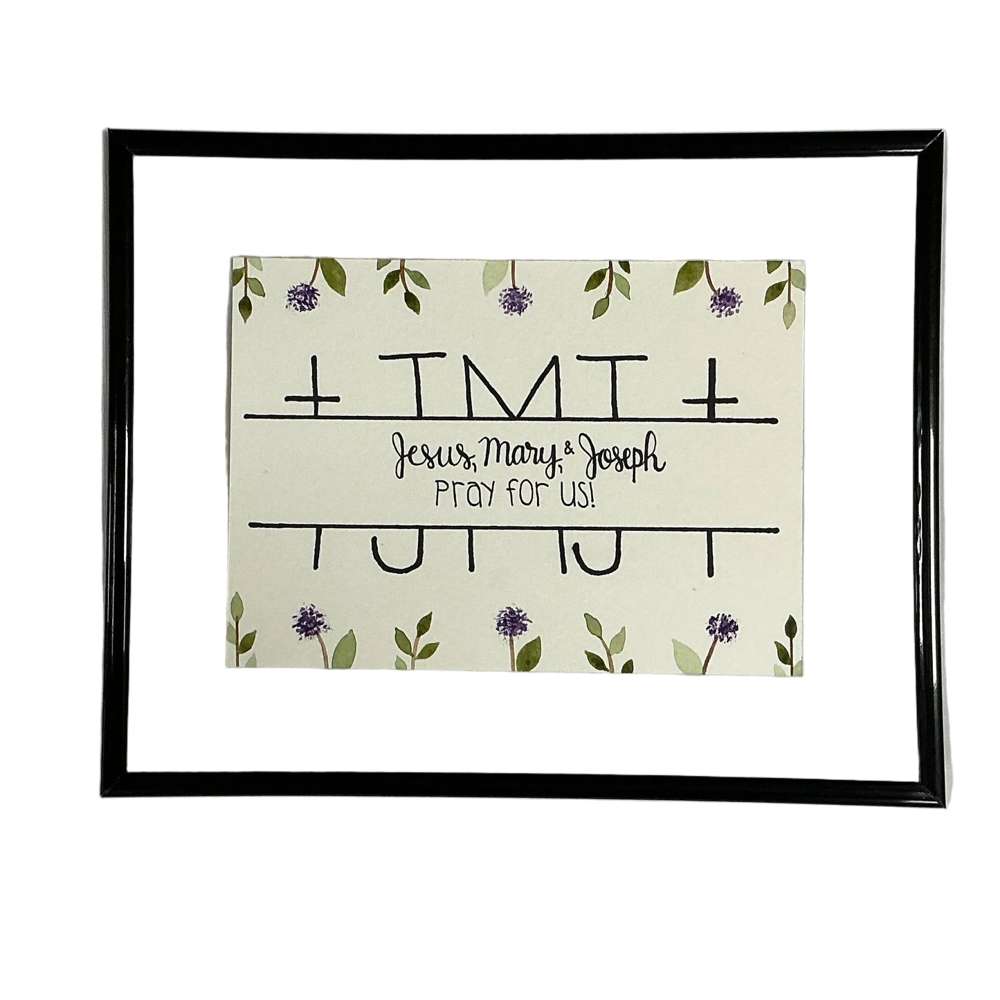Framed artwork with 'Jesus, Mary & Joseph Pray for Us' text and floral design on a white background