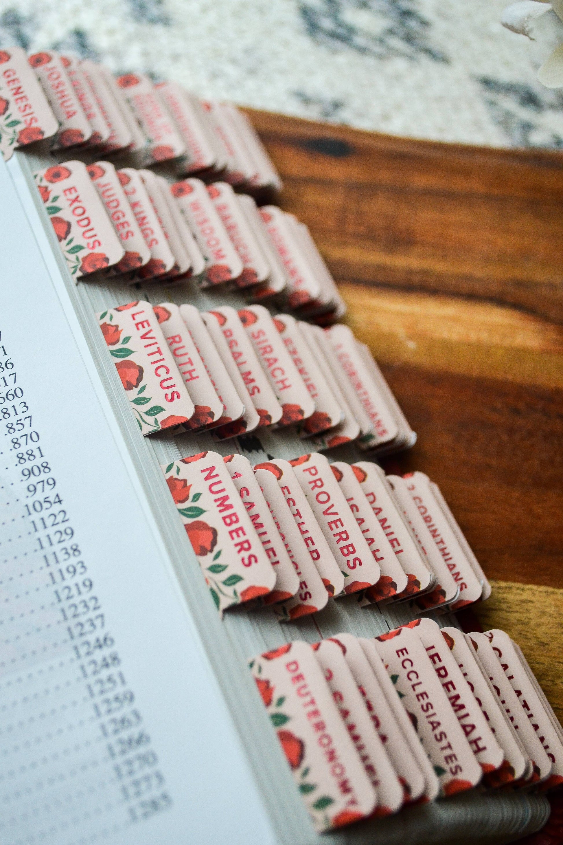 Small religious booklets arranged on a metal tray with a wooden surface underneath.