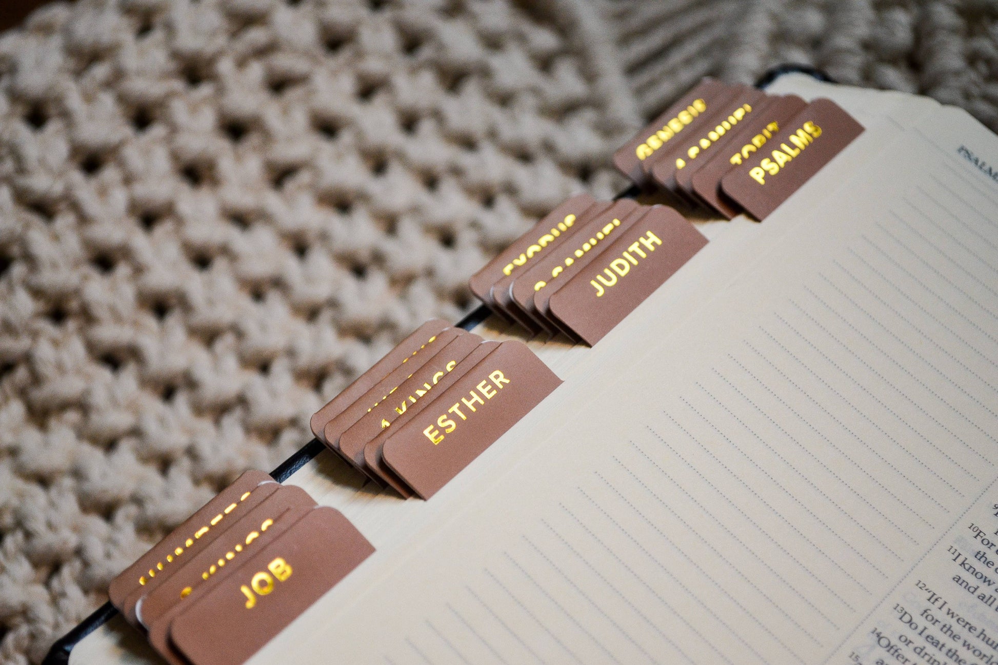 Book with name tags attached to a string on a textured surface