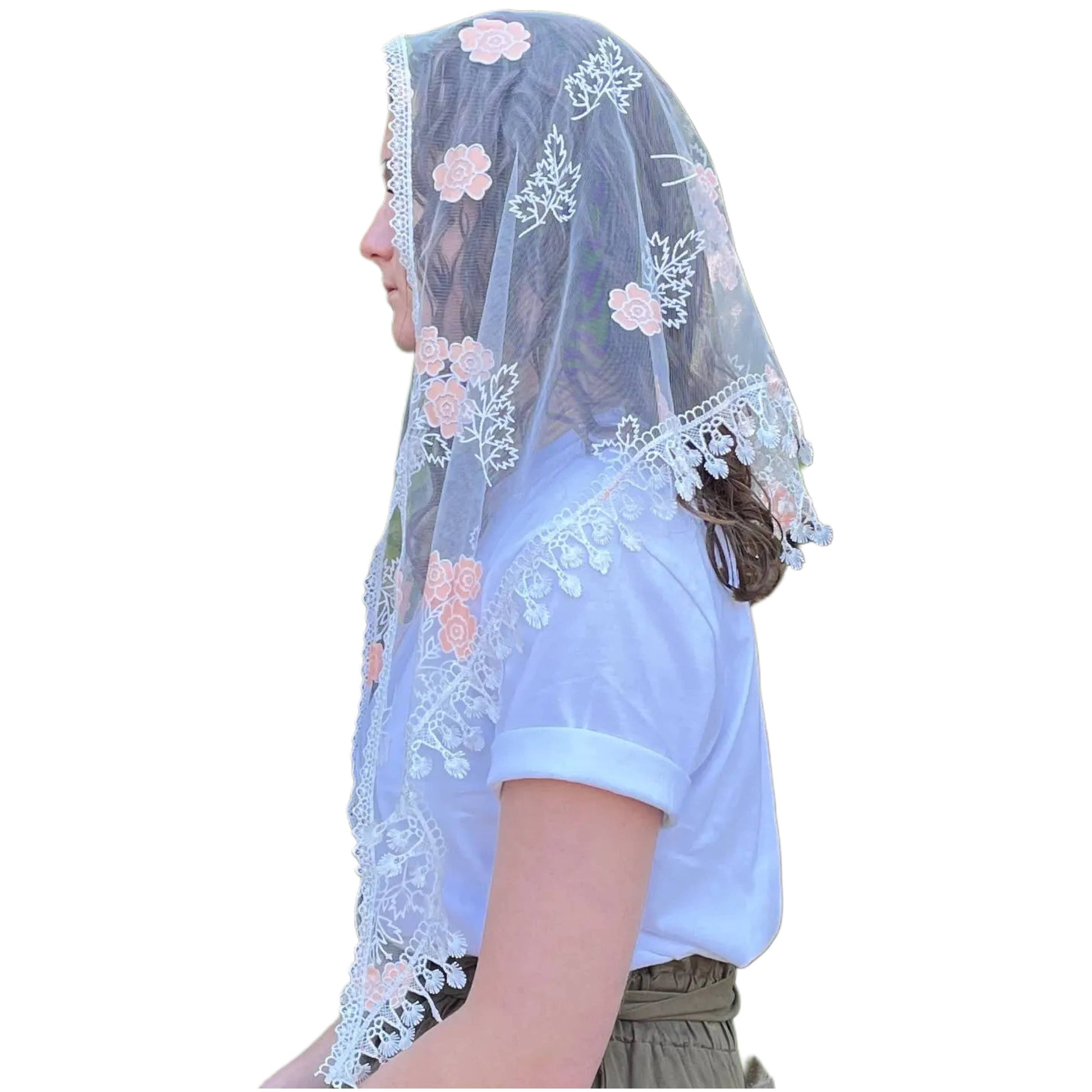 Person wearing a light blue embroidered veil with floral patterns on a white background