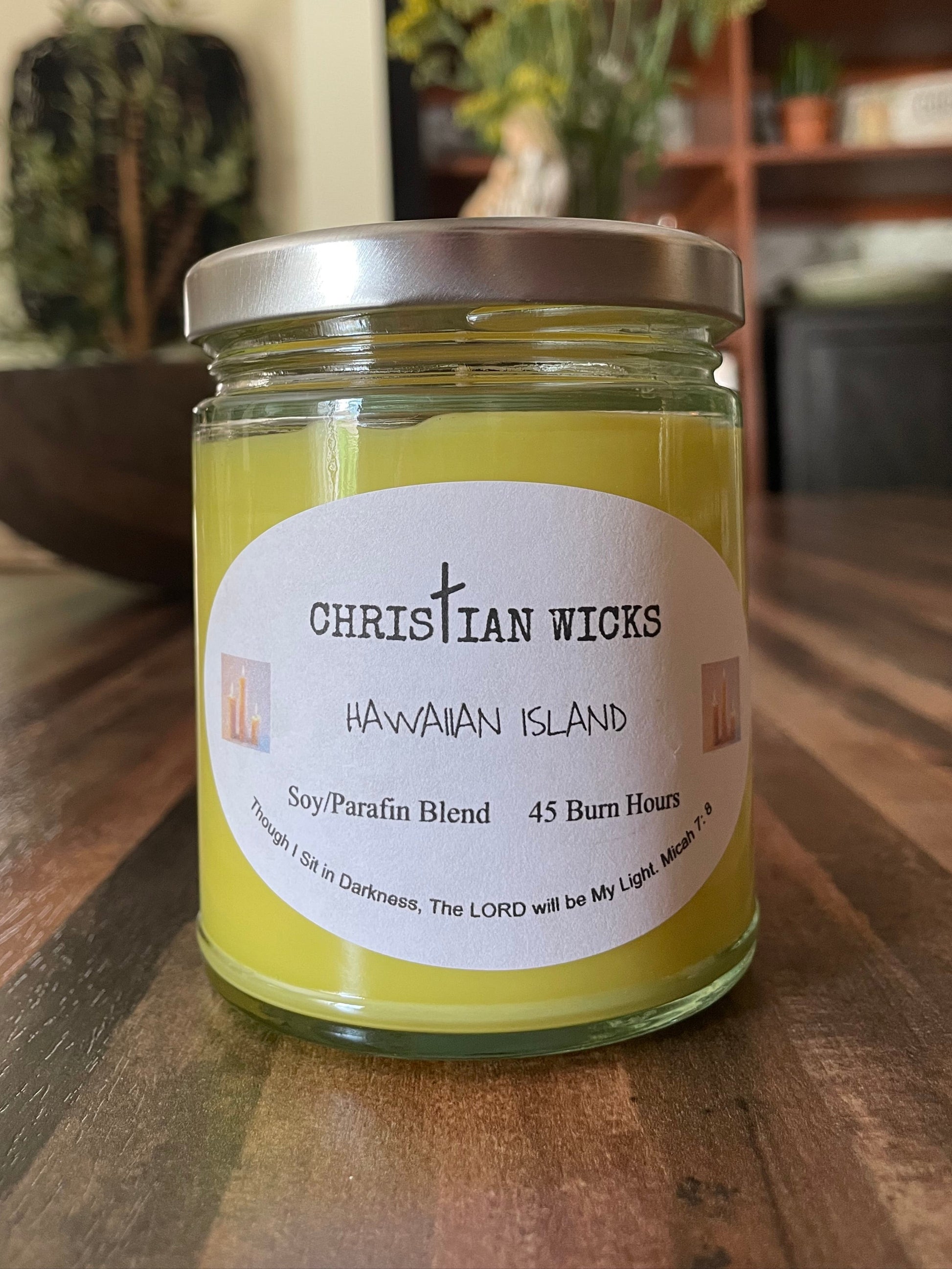 Jar of Christian Wicks Hawaiian Island candle on a wooden surface