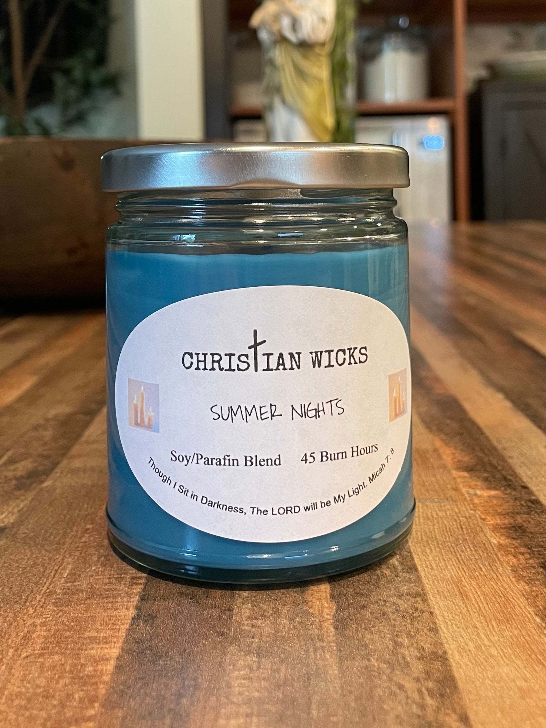 Jar of Christian Wicks caraway seeds on a wooden surface with a blurred indoor background
