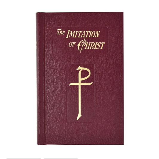 Maroon book titled 'The Imitation of Christ' with gold text