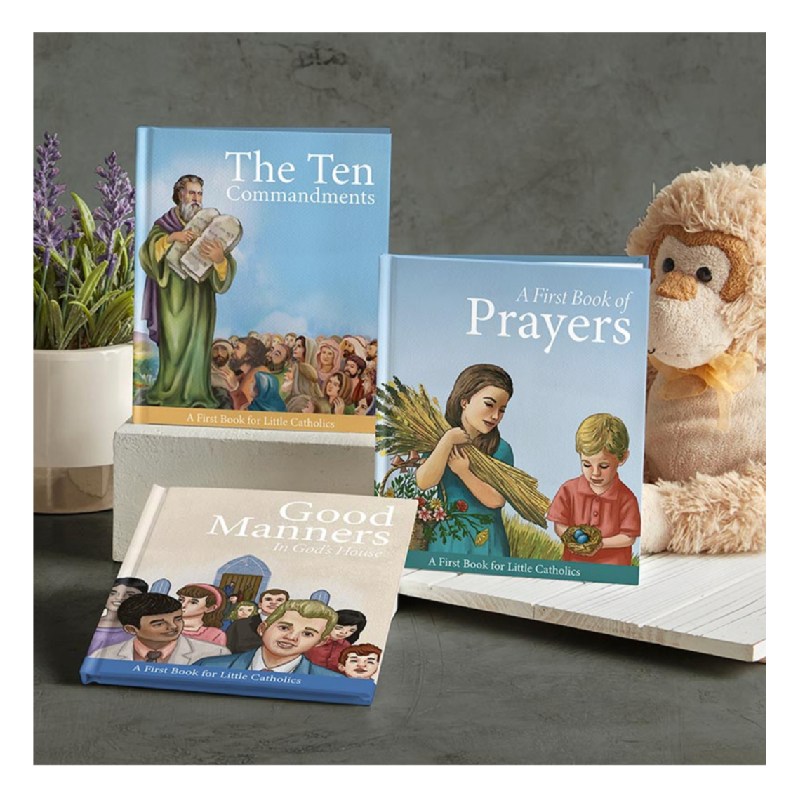 Books and a teddy bear on a gray surface.