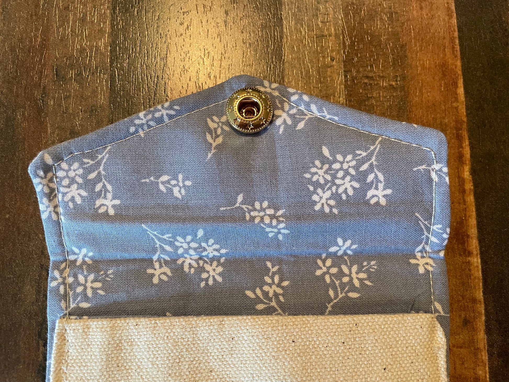 Floral-patterned fabric pouch on a wooden surface
