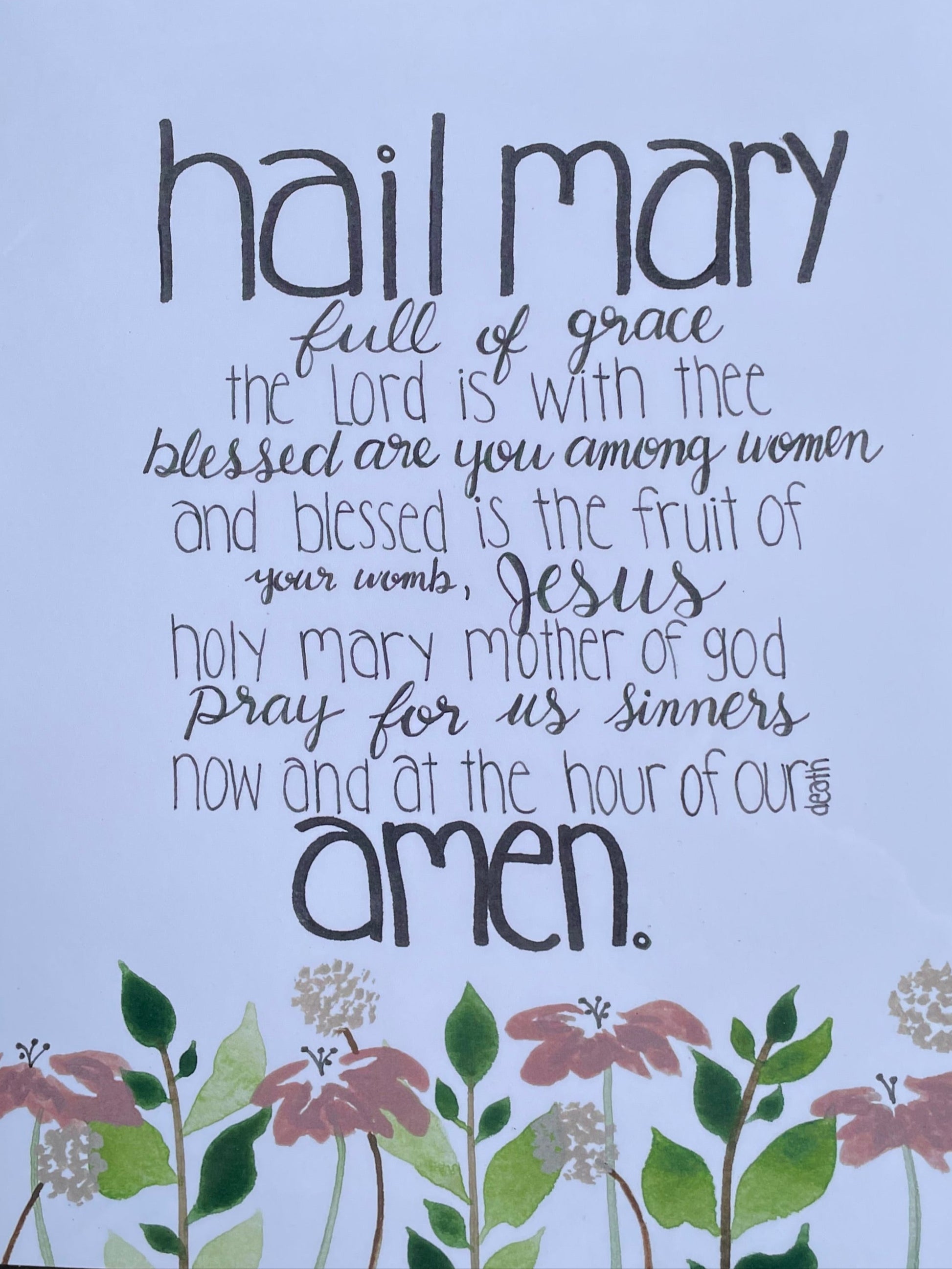 Hail Mary prayer text with floral design on a light blue background