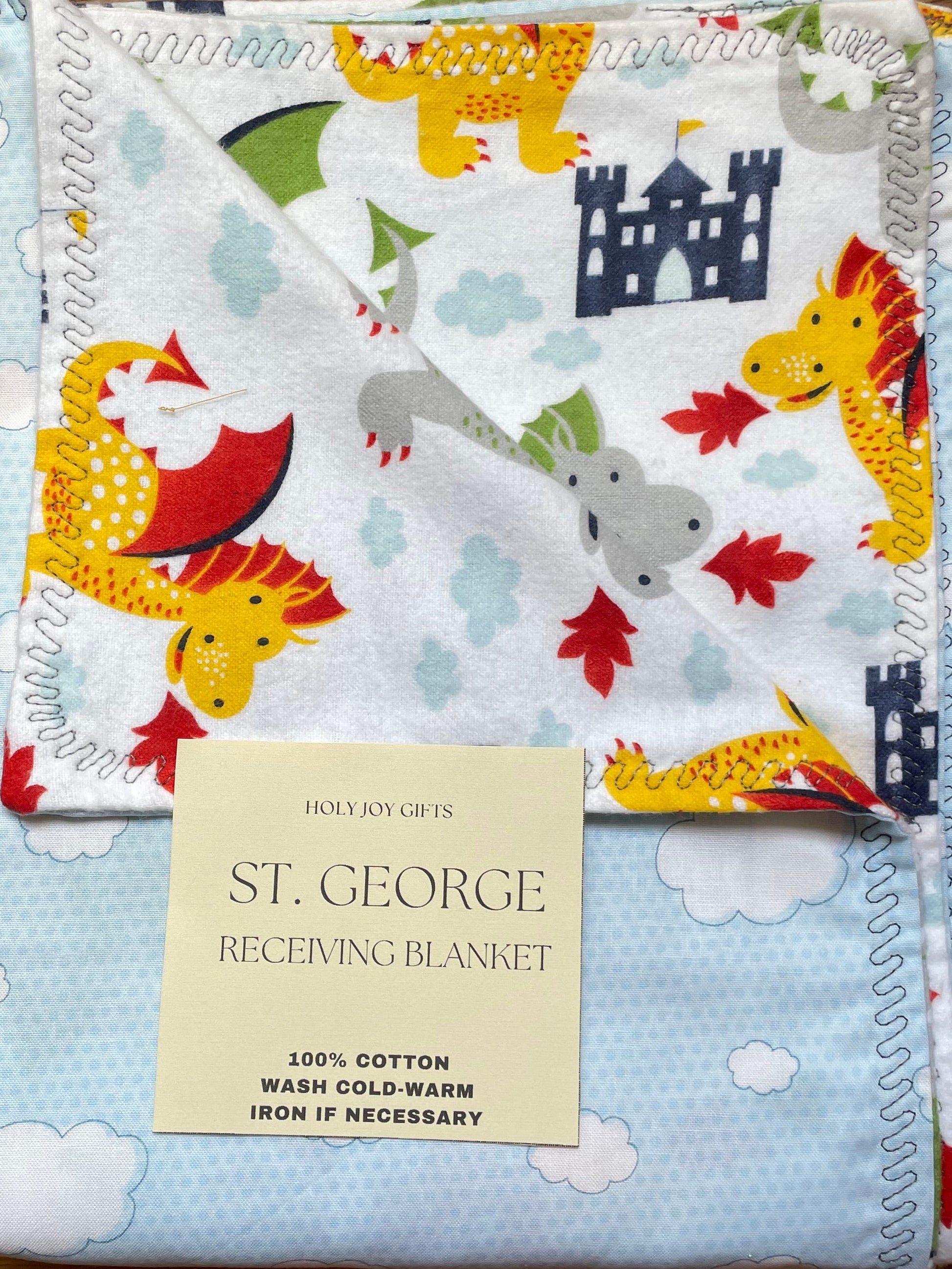 Reversible baby blankets with dragon design on one side and soft blue clouds on the reverse