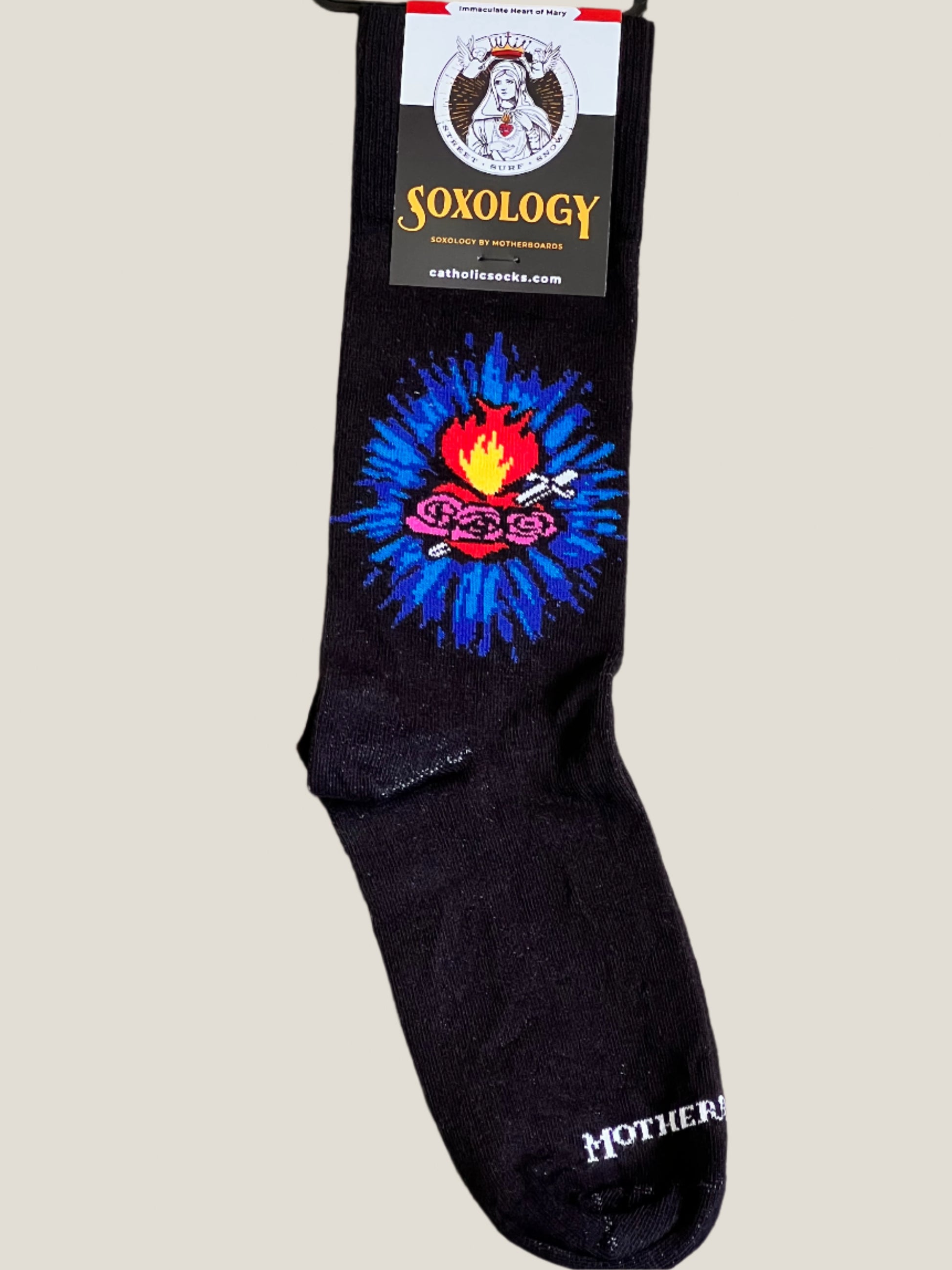Black sock with colorful design and 'SOXOLOGY' branding on a beige background