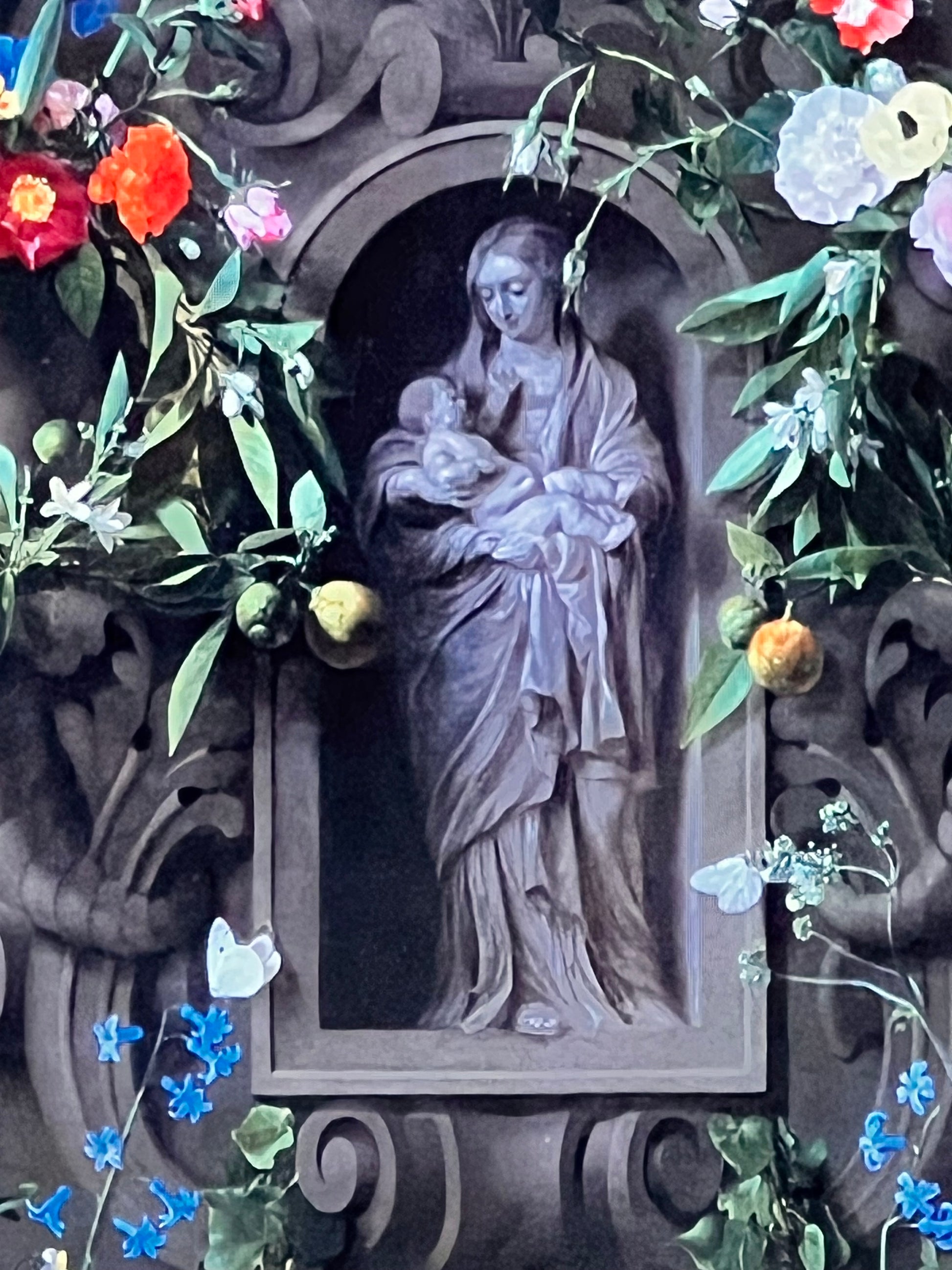 Decorative artwork with a central figure surrounded by flowers and intricate patterns