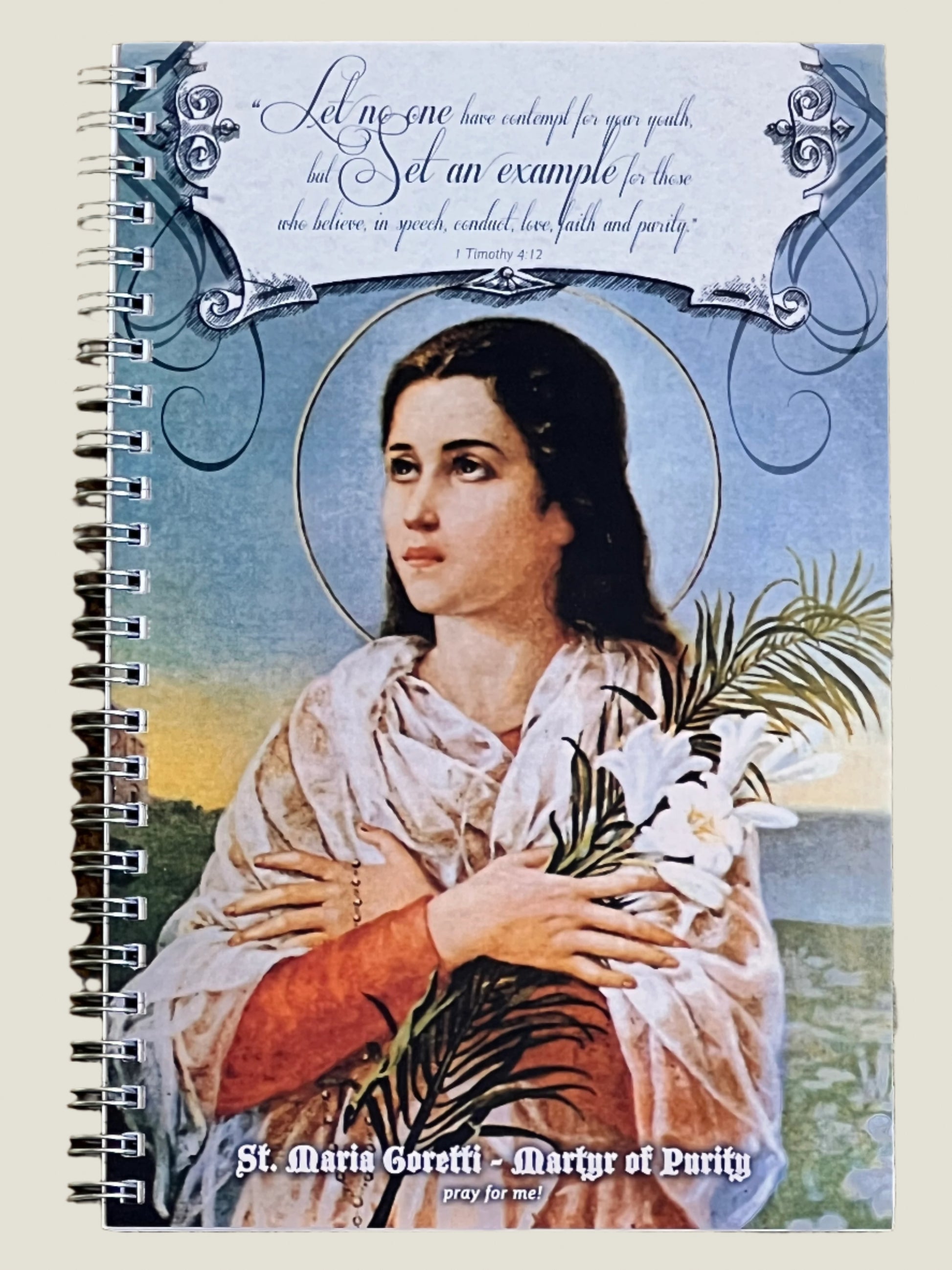 Notebook with a portrait of St. Maria Goretti on the cover, featuring text and decorative elements.