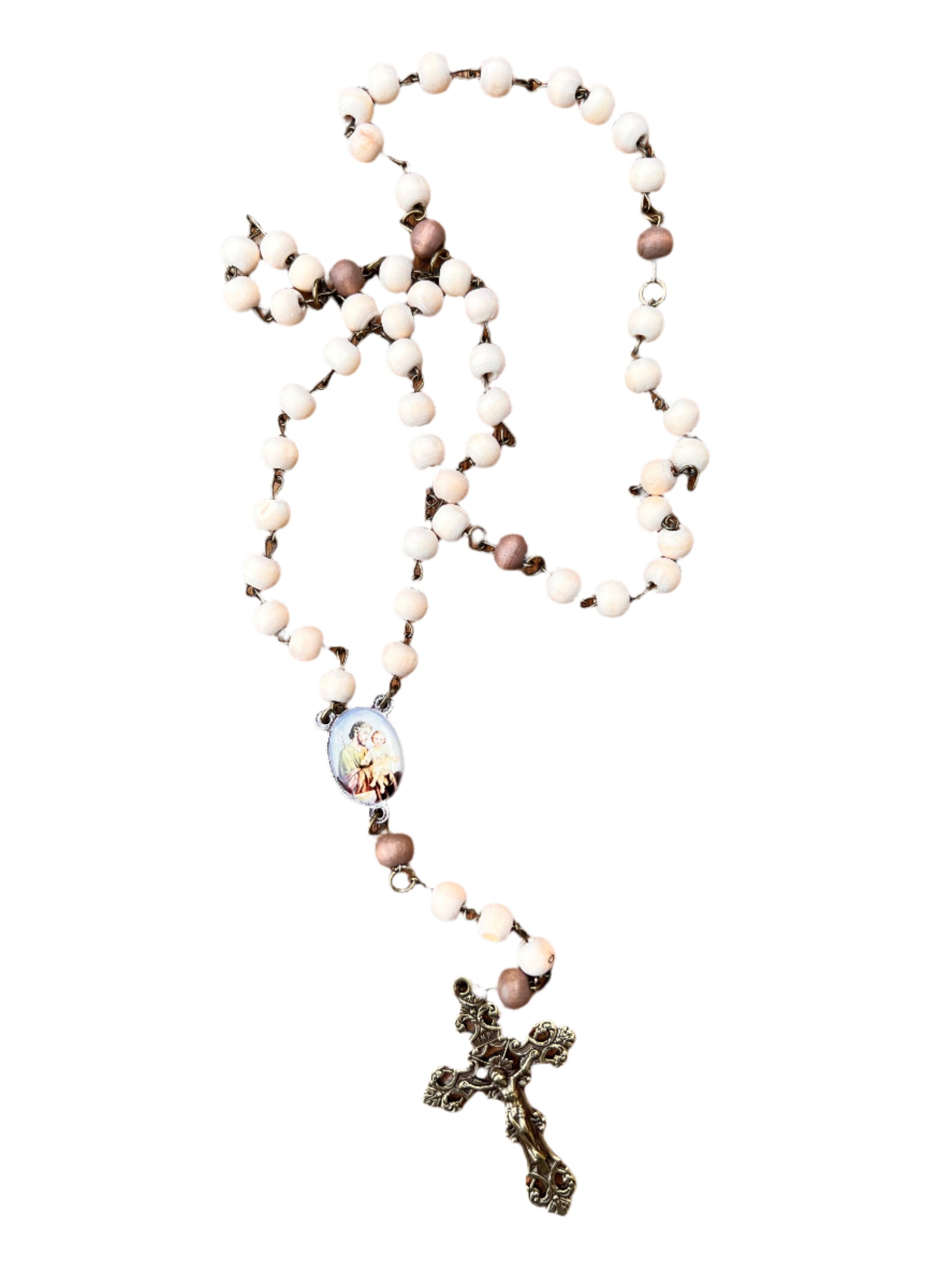 Rosary with white beads and a cross on a wooden surface