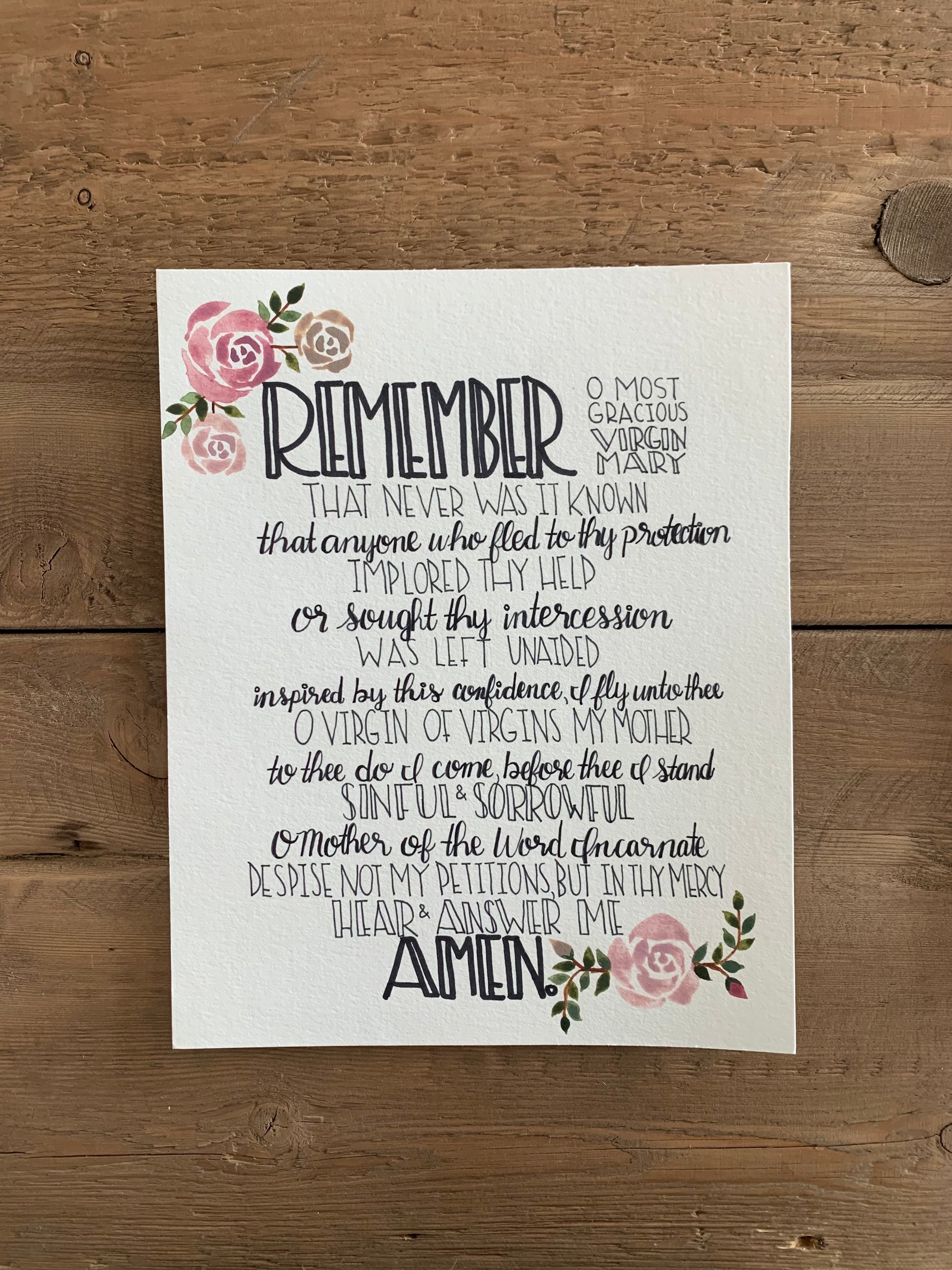 Print with floral designs and text on a wooden surface