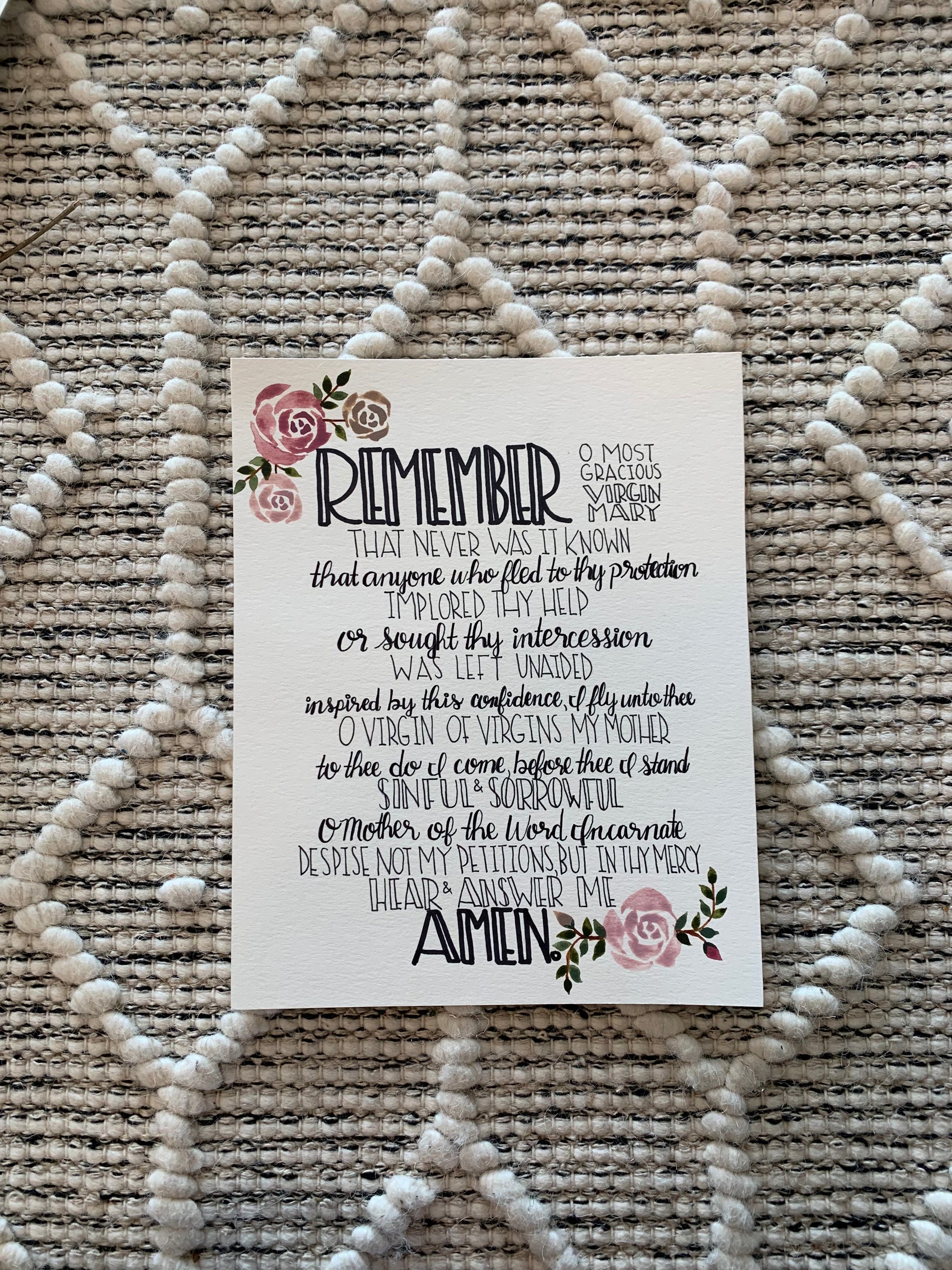 Card with text and floral designs on a textured surface