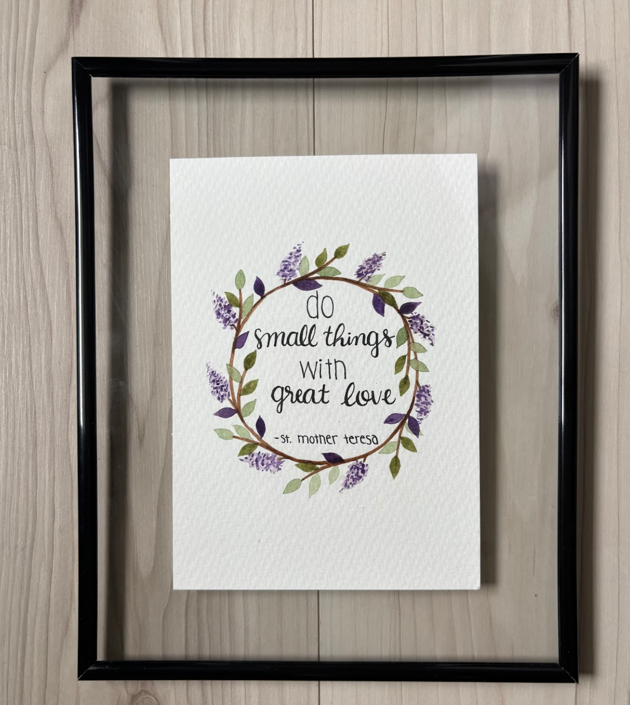 Framed print with floral design and quote from St. Mother Theresa