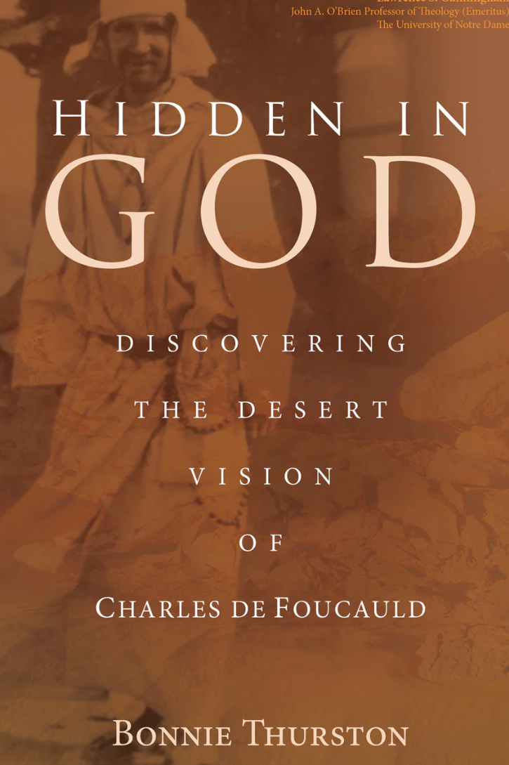 Book cover of 'Hidden in God' with a blurred background of people in robes.