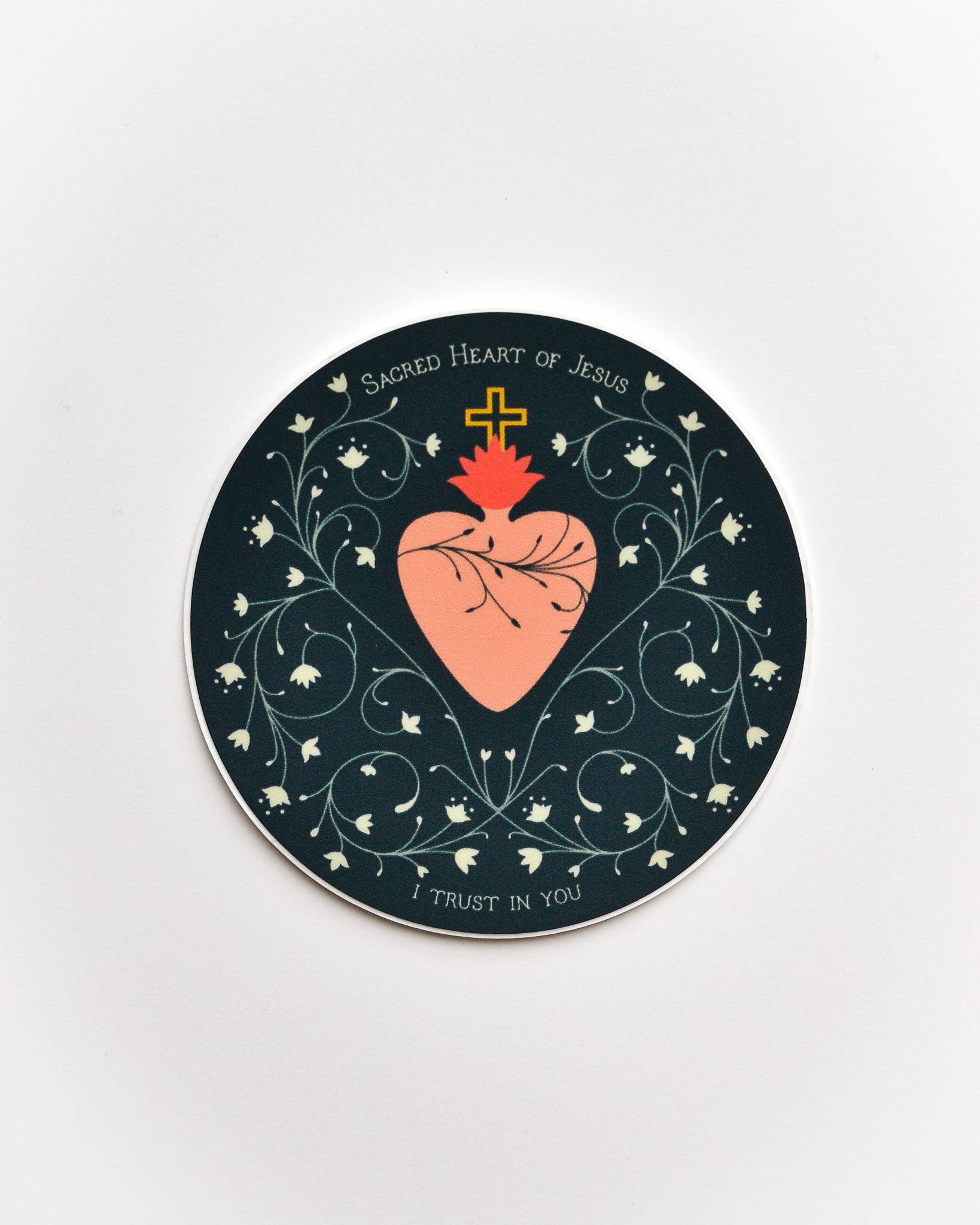 Circular coaster with Sacred Heart of Jesus design on a white background