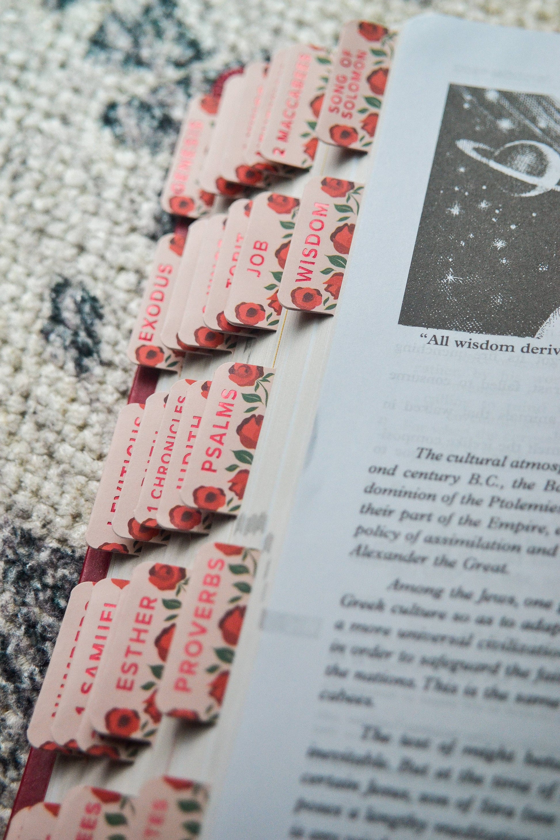 Set of decorative bookmarks with religious text on a book page.