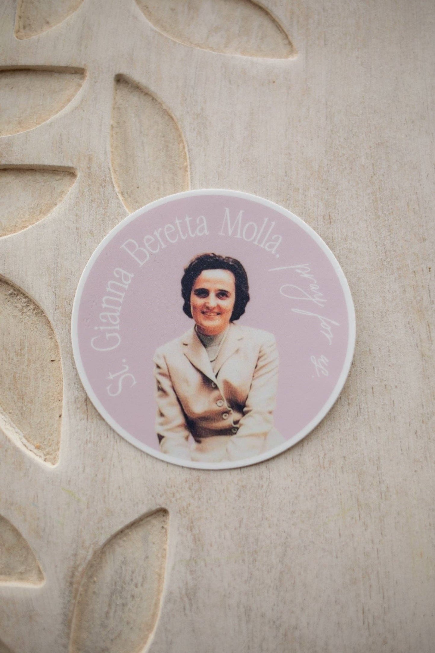Circular photo of a woman on a decorative stone surface
