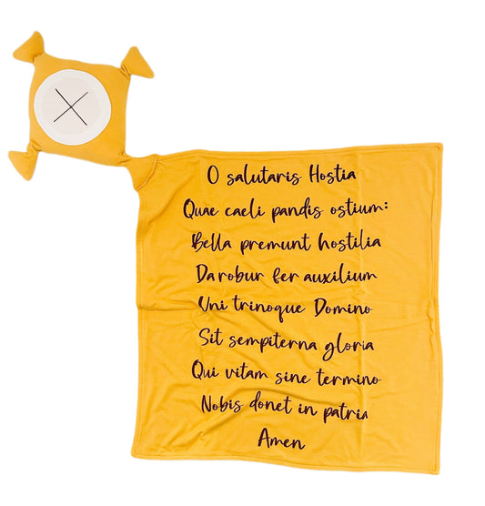 Yellow blanket with Latin text and a small yellow pillow with a white circle and black 'X' on a white background.