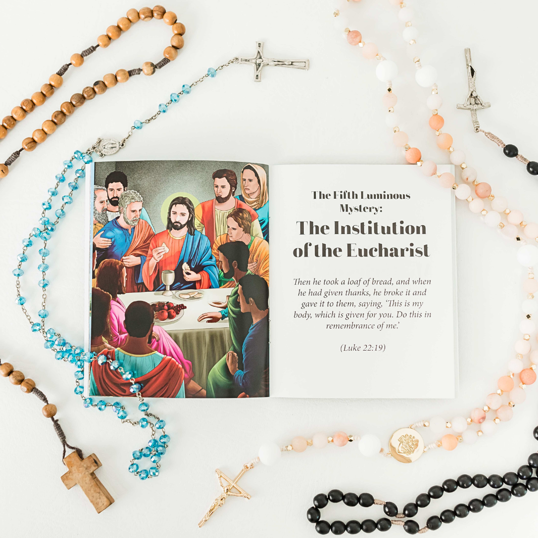 Religious book with illustration of Jesus and disciples, surrounded by rosaries and crosses on a white background.