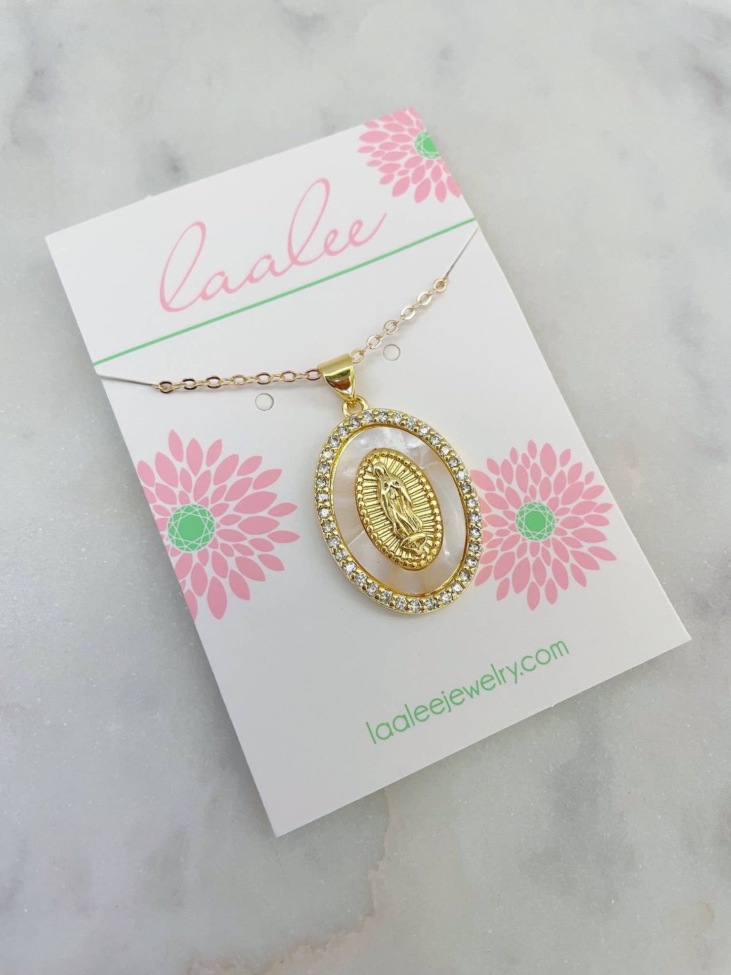 Gold necklace on a card with pink flowers and 'Laalee' branding