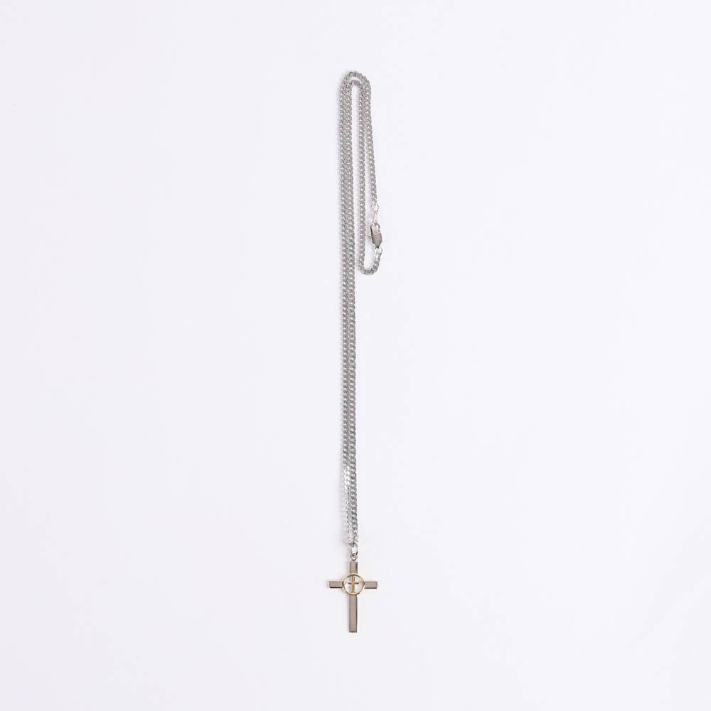 Silver necklace with a cross pendant on a light gray background