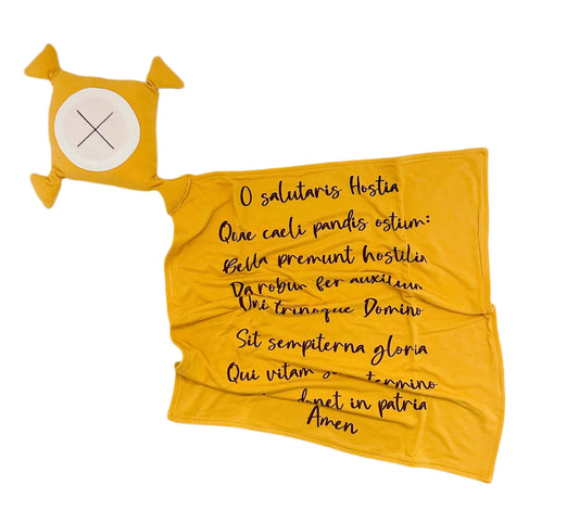 Yellow fabric with black text and a small yellow and white object on a white background