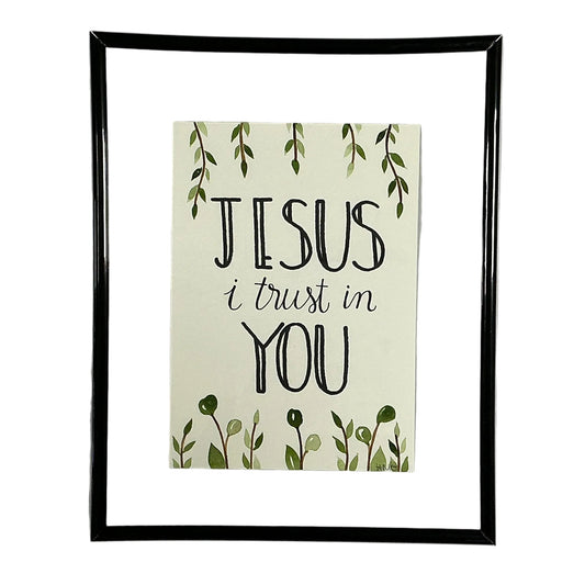 Framed print with 'Jesus I trust in You' text on a white shirt.