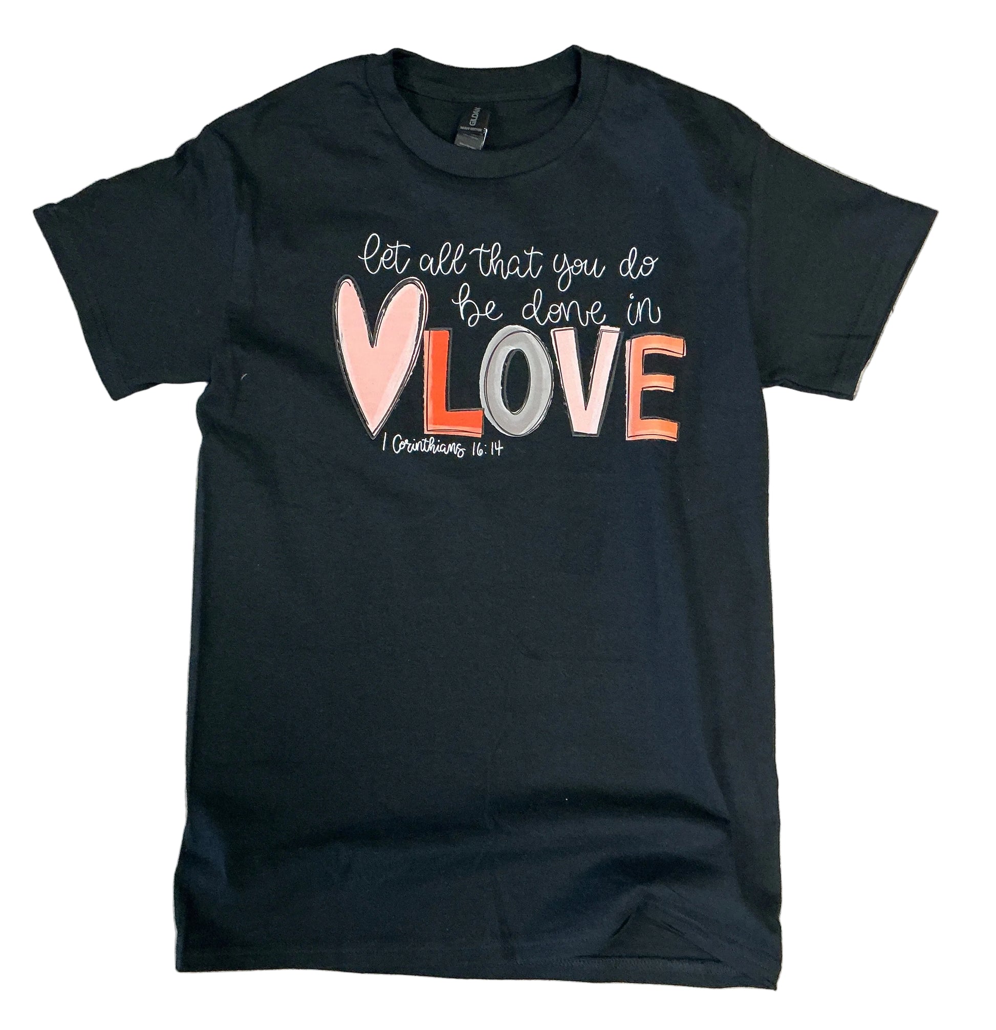Black t-shirt with colorful text design on a gray tiled floor