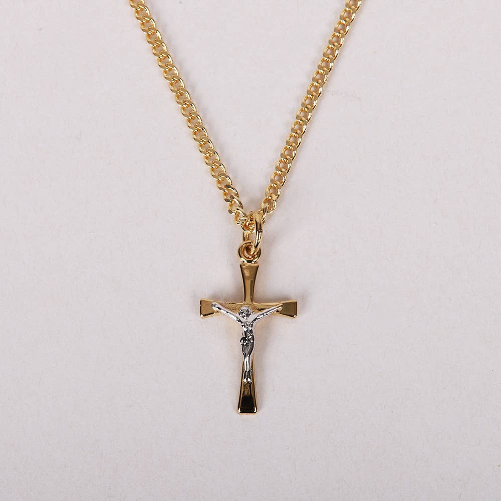 Gold cross necklace with chain on a light gray background
