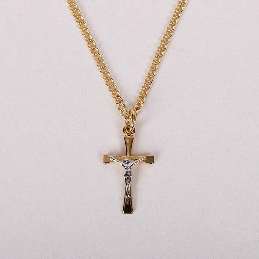 Gold cross necklace with chain on a light gray background