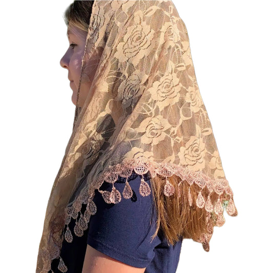 Lace veil with floral patterns and tassels on a plain background