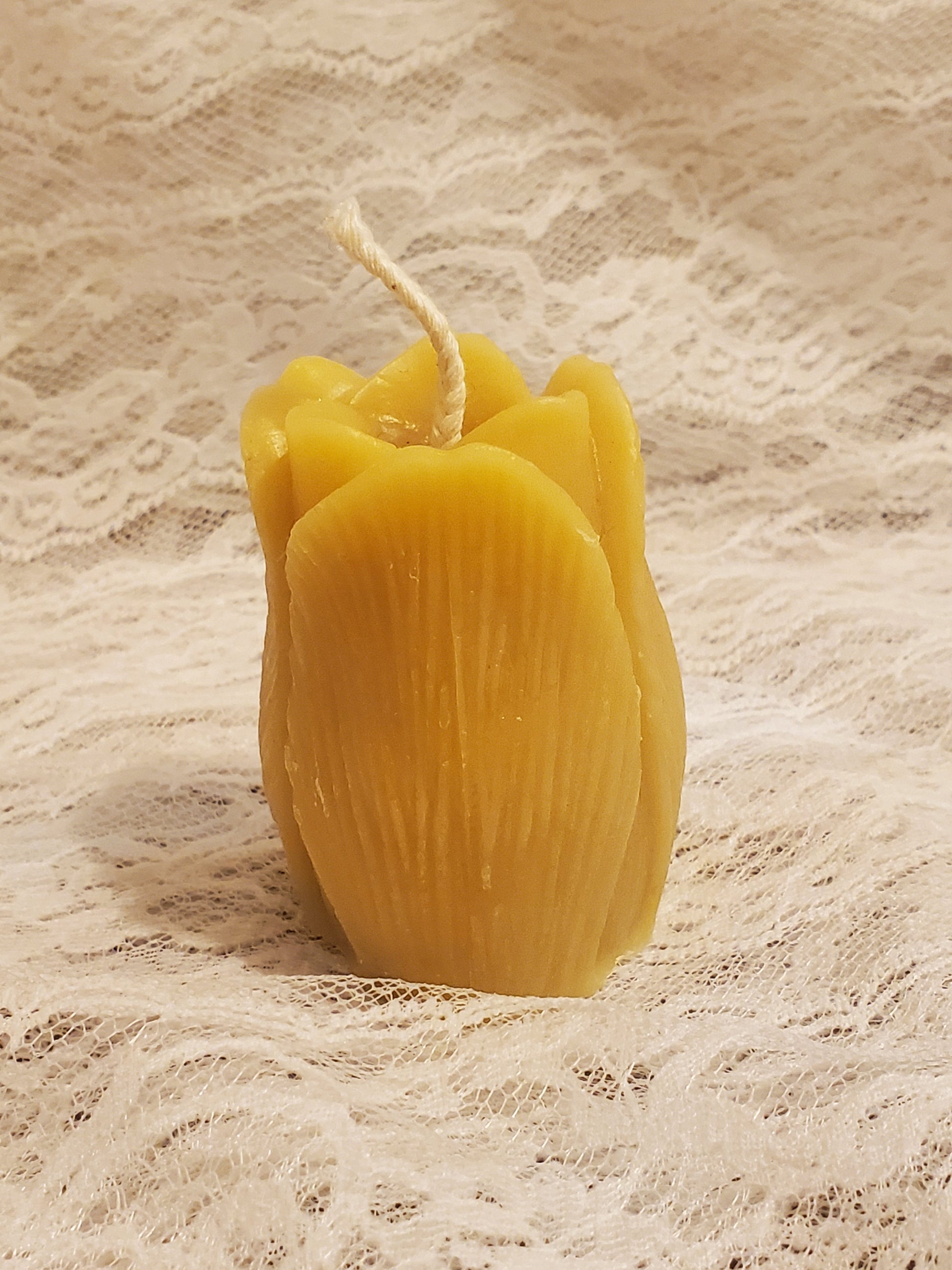 Yellow candle on a textured beige background