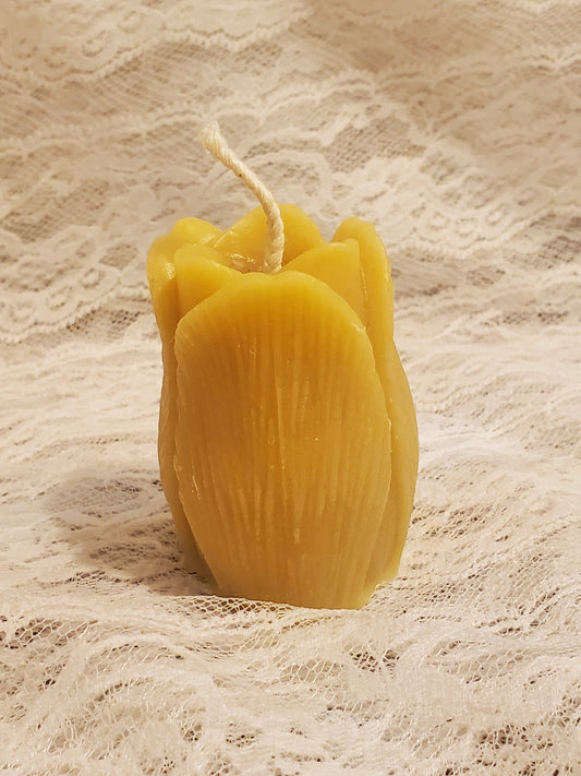 Yellow candle on a textured beige background