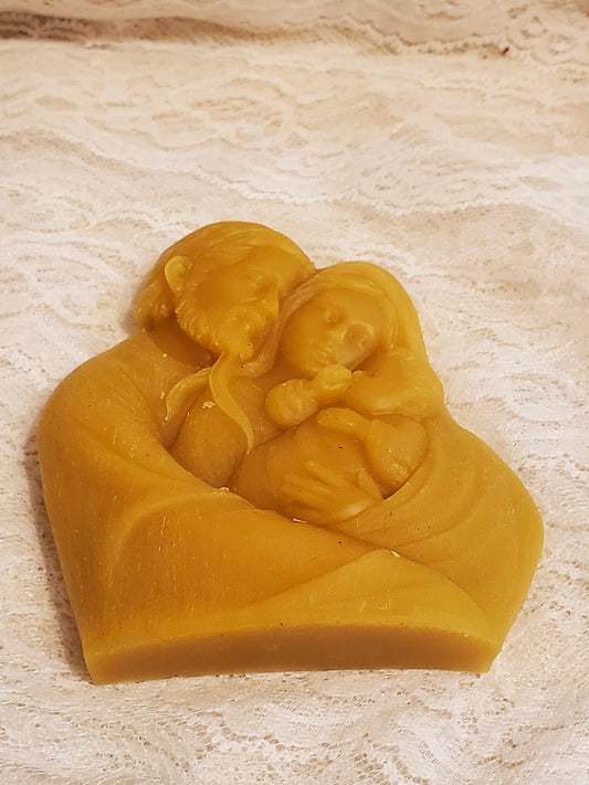 Beeswax design of the Holy Family on a beige background