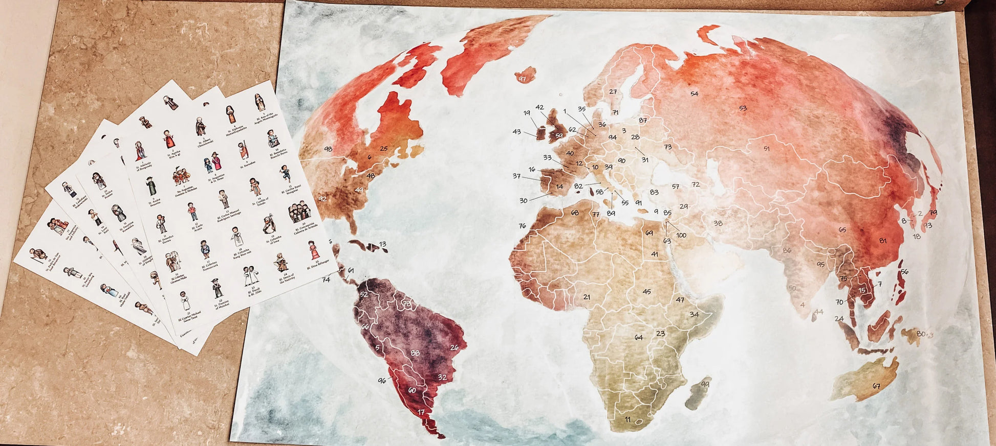World map poster with a set of stamps on a cardboard surface