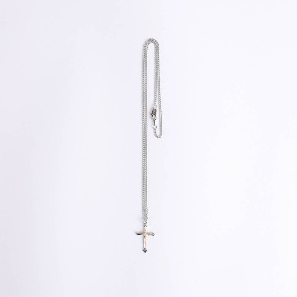 Silver chain necklace with a cross pendant on a white background