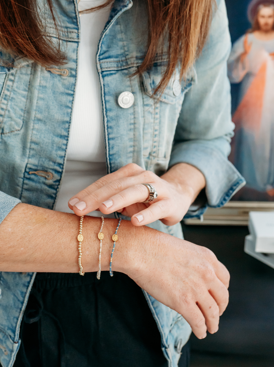 Person wearing multiple bracelets on a blurred background