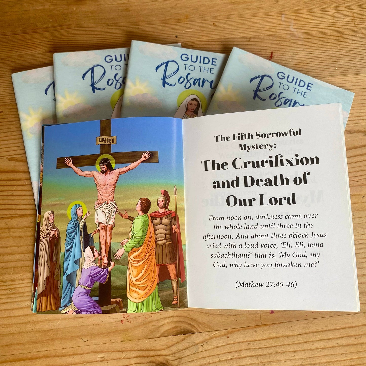 Open book to a page titled “The Crucifixion and death of our Lord” with illustrations.