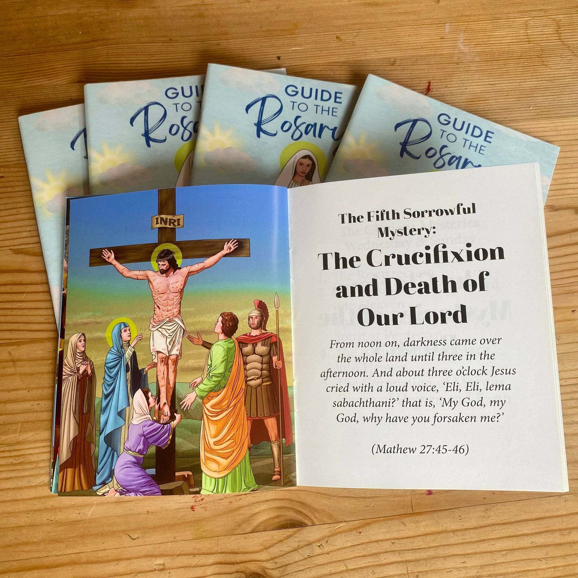 Open book to a page titled “The Crucifixion and death of our Lord” with illustrations.